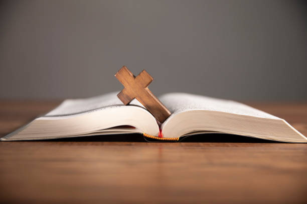 istock cross on open bible wooden table 1746936830
