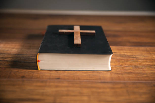 istock cross on open bible wooden table 1746936866