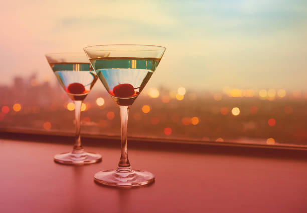 istock Martini glasses against a city background. 1746940166