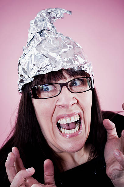Tin foiled woman A goofy woman wearing a protective tin foil hat. tin foil hat stock pictures, royalty-free photos & images