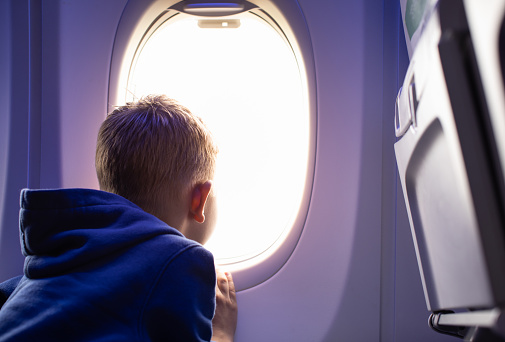 Boy traveling by the airplane.