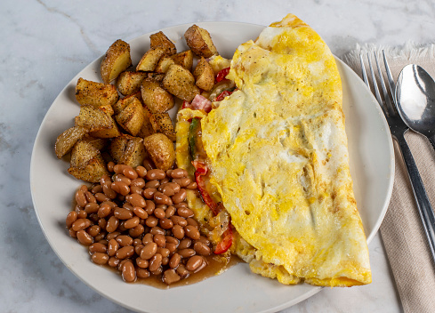 wester omelet served with baked beans and homefries