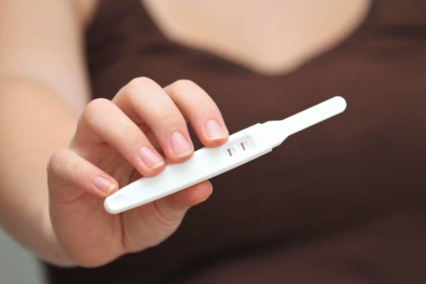 istock positive pregnancy test shown by young female 1746946817