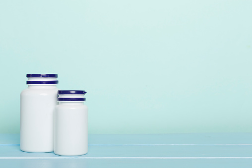 Plastic bottles for vitamins on wooden table