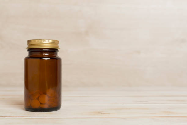 Plastic bottle for vitamins on wooden table
