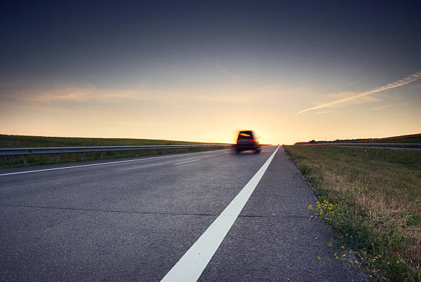 istock A highway with one car driving towards the horizon 174695020
