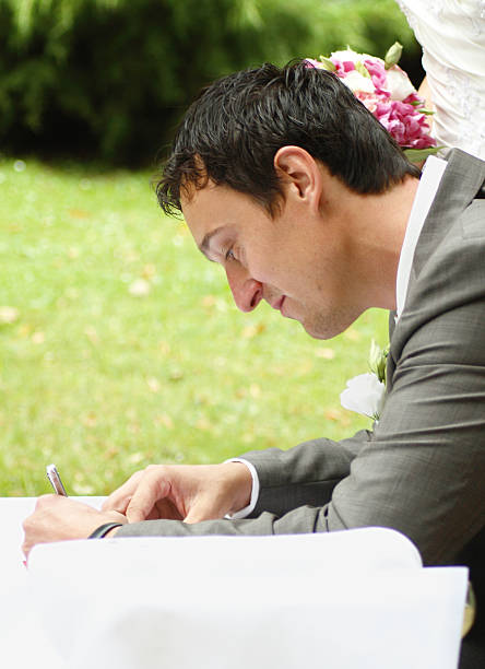 istock Groom signing the marriage contract 174695202