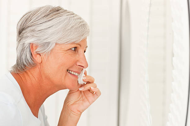 istock Senior woman applying make-up 174695406