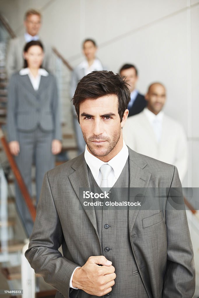 Close-up of businessman with his colleagues standing behind Adult Stock Photo