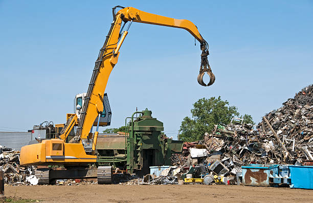 istock Crane and metal compactor at recycling facility 174695582