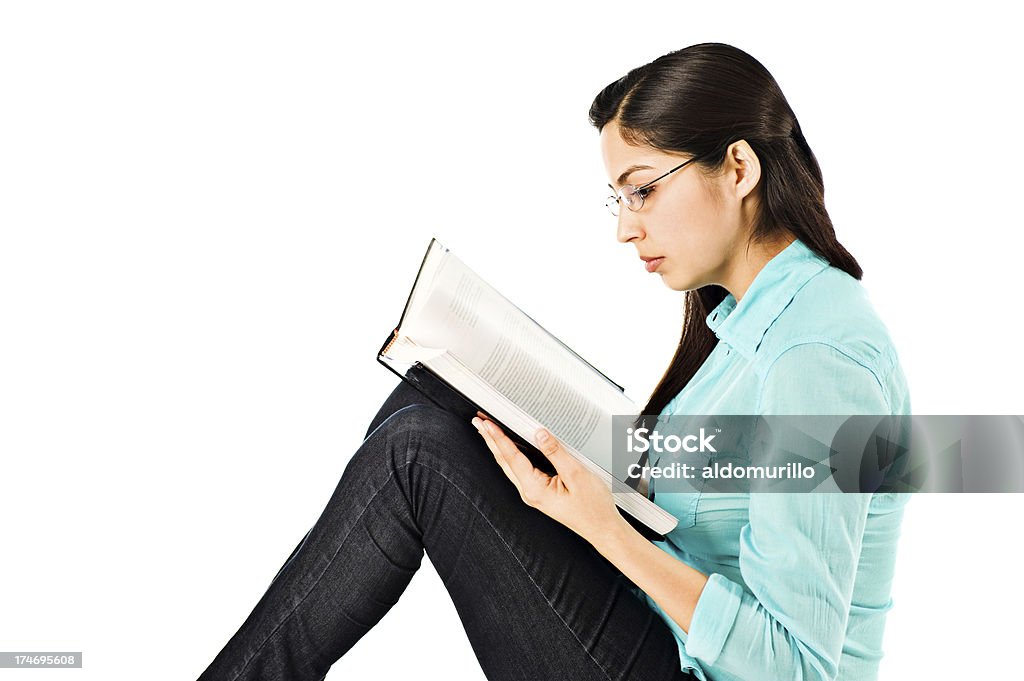 Young woman reading a book Young woman sitting and reading a book 20-29 Years Stock Photo