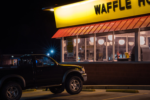 Calvert City, KY, US-December 2, 2021 : Waffle House exterior at night. Waffle House, is an iconic restaurant chain with more than 2,100 locations in 25 states in the United States.