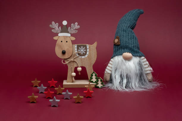 istock Elf in grey hat with reindeer and christmas decoration. 1746957727