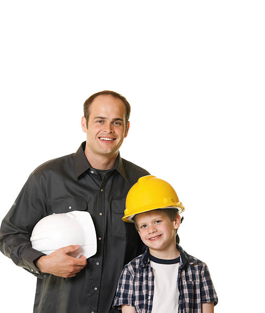Child and man or Father Wearing Hard Hat Construction stock photo