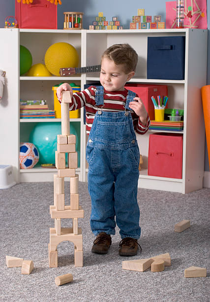 istock Boy Building With / Looking At Wooden Toy Blocks, Vertical 174696536