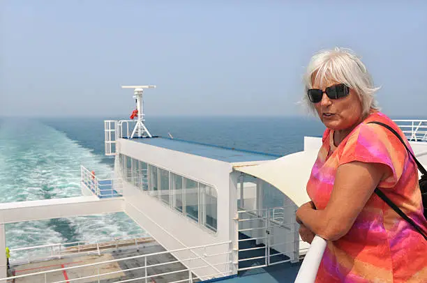 Elderly woman with sunglasses on the ferry from Dover to Calais.