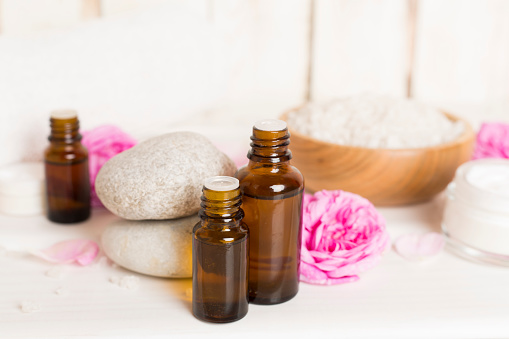 Spa composition with pink roses on wooden table