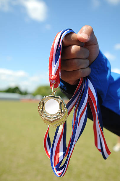 istock Hand holding a winning sports medal 174696732