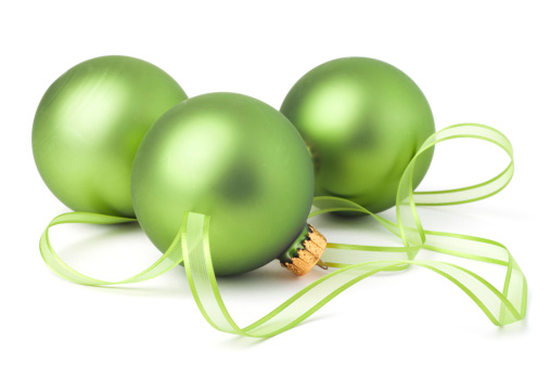 Green Christmas ornaments and ribbon isolated on white with soft shadow.