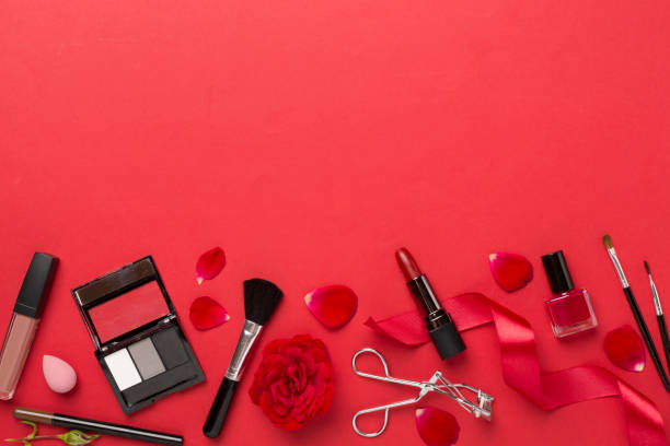 istock Flat lay with makeup products and tools with flowers on color background 1746971430