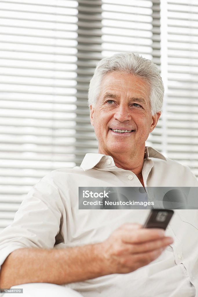 Lächelnd senior Mann hält ein cellphone - Lizenzfrei 60-64 Jahre Stock-Foto