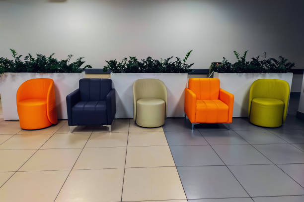 istock Chairs, tables and sofas in the corridor for visitors who will be waiting for their turn to enter the rented premises for various tasks and commercial services 1746971925