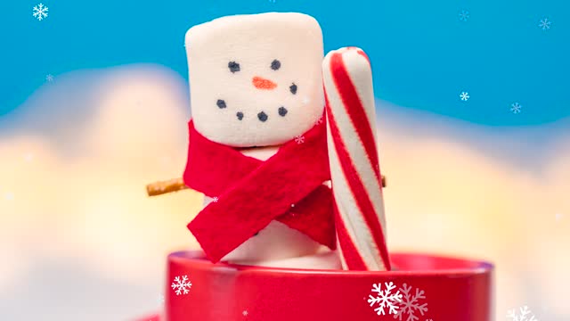 Marshmallow Snowman With Peppermint Stick in Hot Cocoa in the Snow