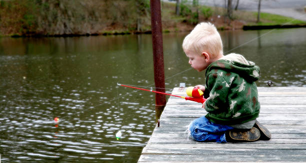 istock Little boy fishing 174697658