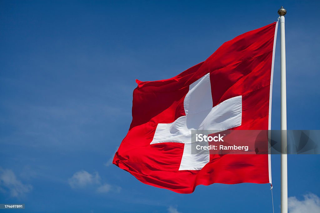 Switzerland's national flag flying Swiss flag waving in the wind. Swiss Flag Stock Photo