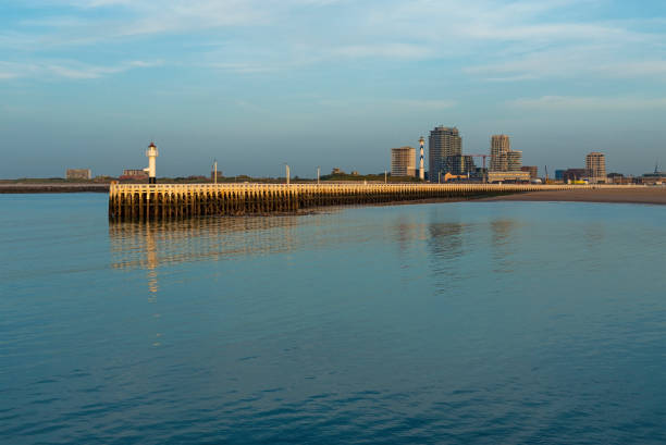Cityscape of Oostende (Ostend) with pier and modern apartment buildings at sunset, Belgium.