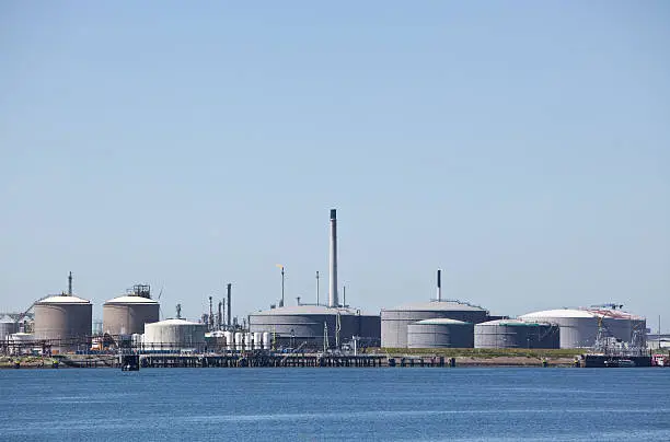 Petrochemical industry with oil storage tanks near water