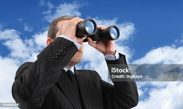 A Businessman Looking Through Binoculars Stock Photo - Download Image Now - Binoculars, Suit, Looking Through An Object