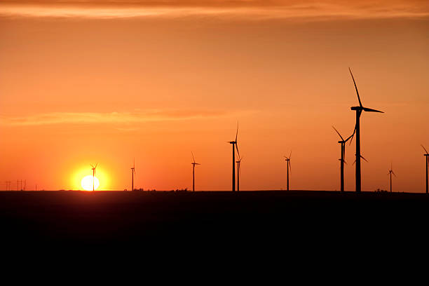 istock Warm Sunset Silhouettes Wind Turbines in Western Kansas 174698400