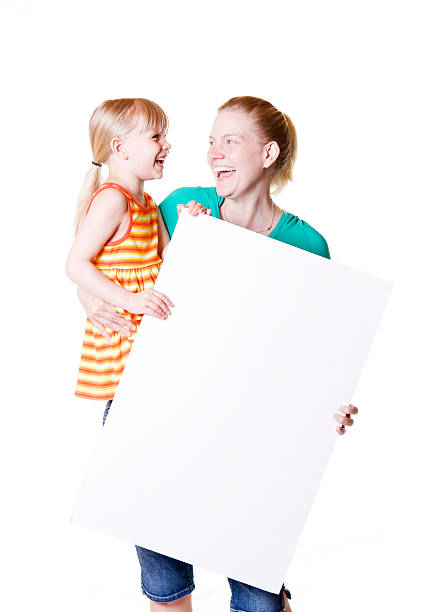 Child and Woman or Mother Holding Blank Cardboard Poster Sign stock photo