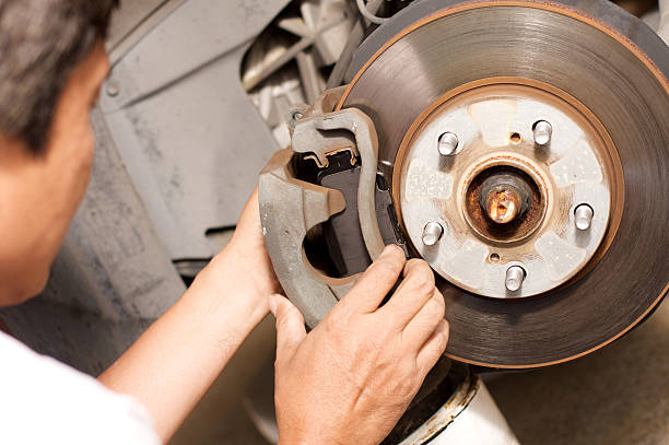 istock Man changing car brake pads on a car 174700198