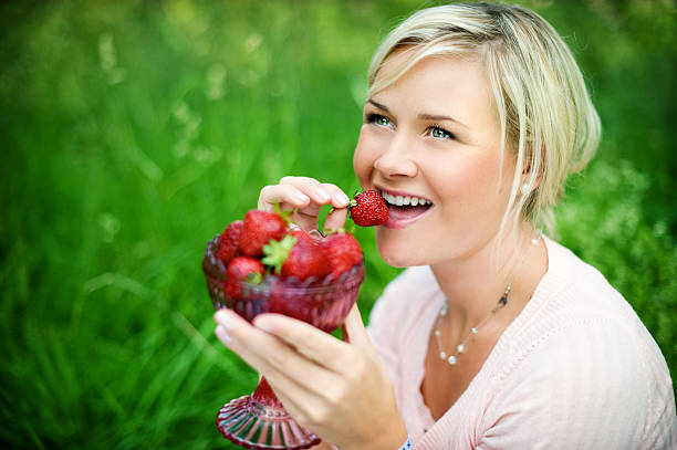 istock woman eating strawberries 174700385