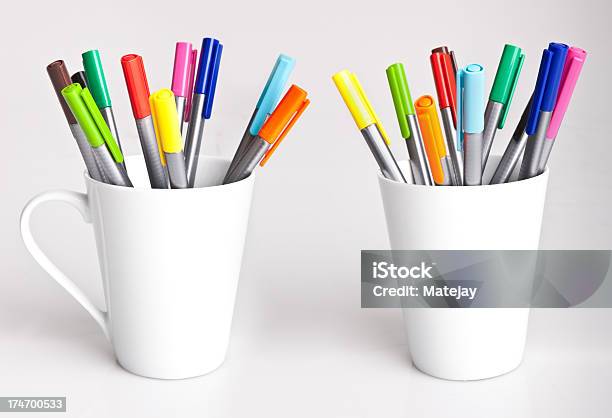 Two White Mugs Stocked With Bright Colored Felt Tip Pens Stock Photo - Download Image Now