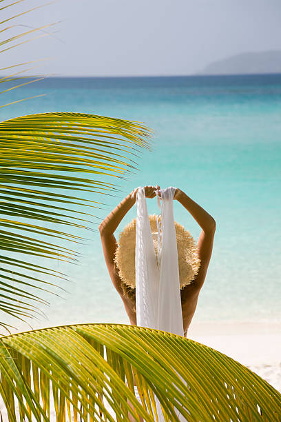 istock woman in front of palm tree 174700968