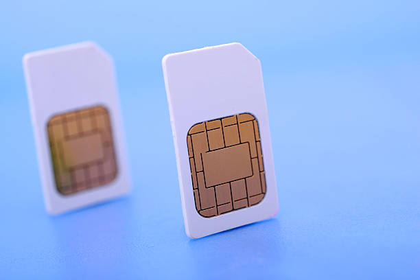 Two SIM cards on blue background stock photo