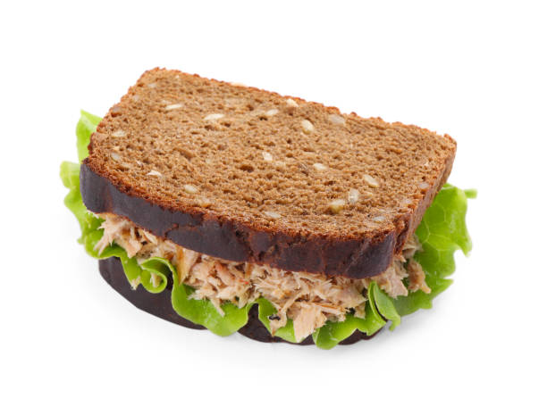 istock Delicious sandwich with tuna and lettuce leaves on white background 1747015202