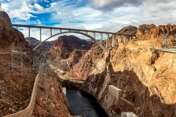 Photo of Panoramic view of the Mike O'Callaghan-Pat Tillman Memorial Bridge, next to the Hoover Dam on the Colorado River, in the USA in the states of Arizona and Nevada under a warm blue sky.
