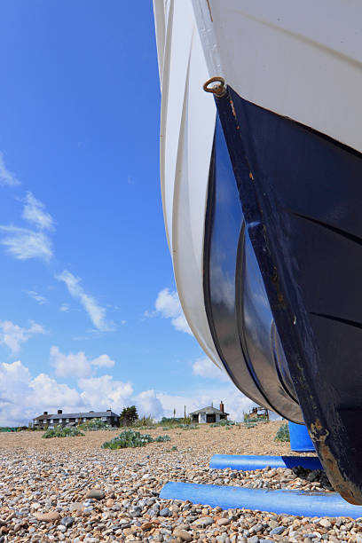 istock blue and white fishing boat on shingle 174701808