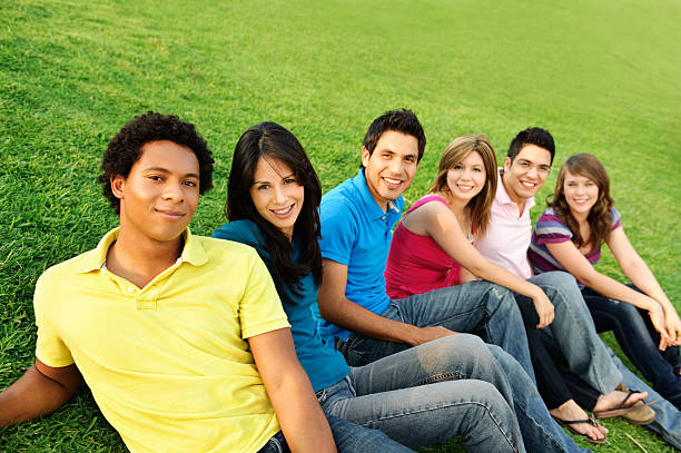 istock Group of friends sitting on the grass 174701902