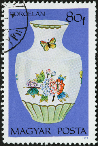 decorative porcelain vase with flowers and a butterfly.