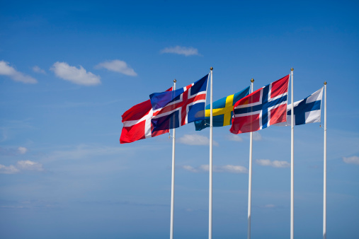 The flags of the Nordic Countries waving in the wind.