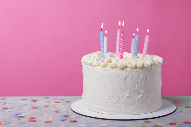 istock Delicious cake with cream and burning candles on grey table. Space for text 1747025789