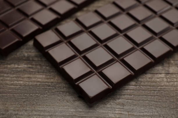 istock Delicious dark chocolate bars on wooden table, closeup 1747027150
