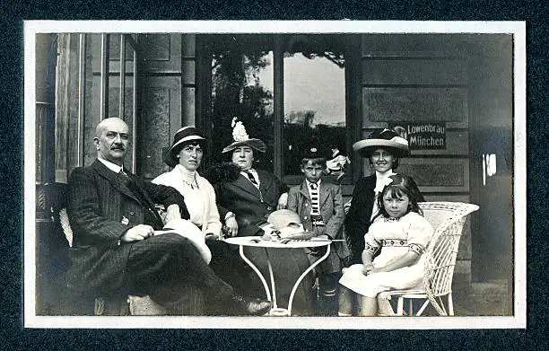 "Vintage photograph of an Edwardian family on a day out at a cafe. Knokke, Belgium."