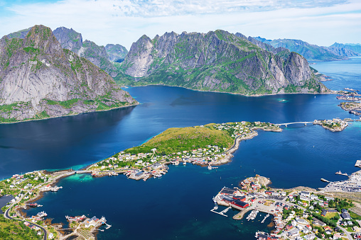 View from the Reinebringen mountain (448 m) over Reinefjorden to the fishing village Reine and the mountain range of the Lofoten, Norway