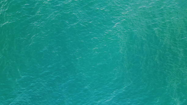 istock Turquoise water waving agitated aerial view. Blue sea surface making small waves 1747036889